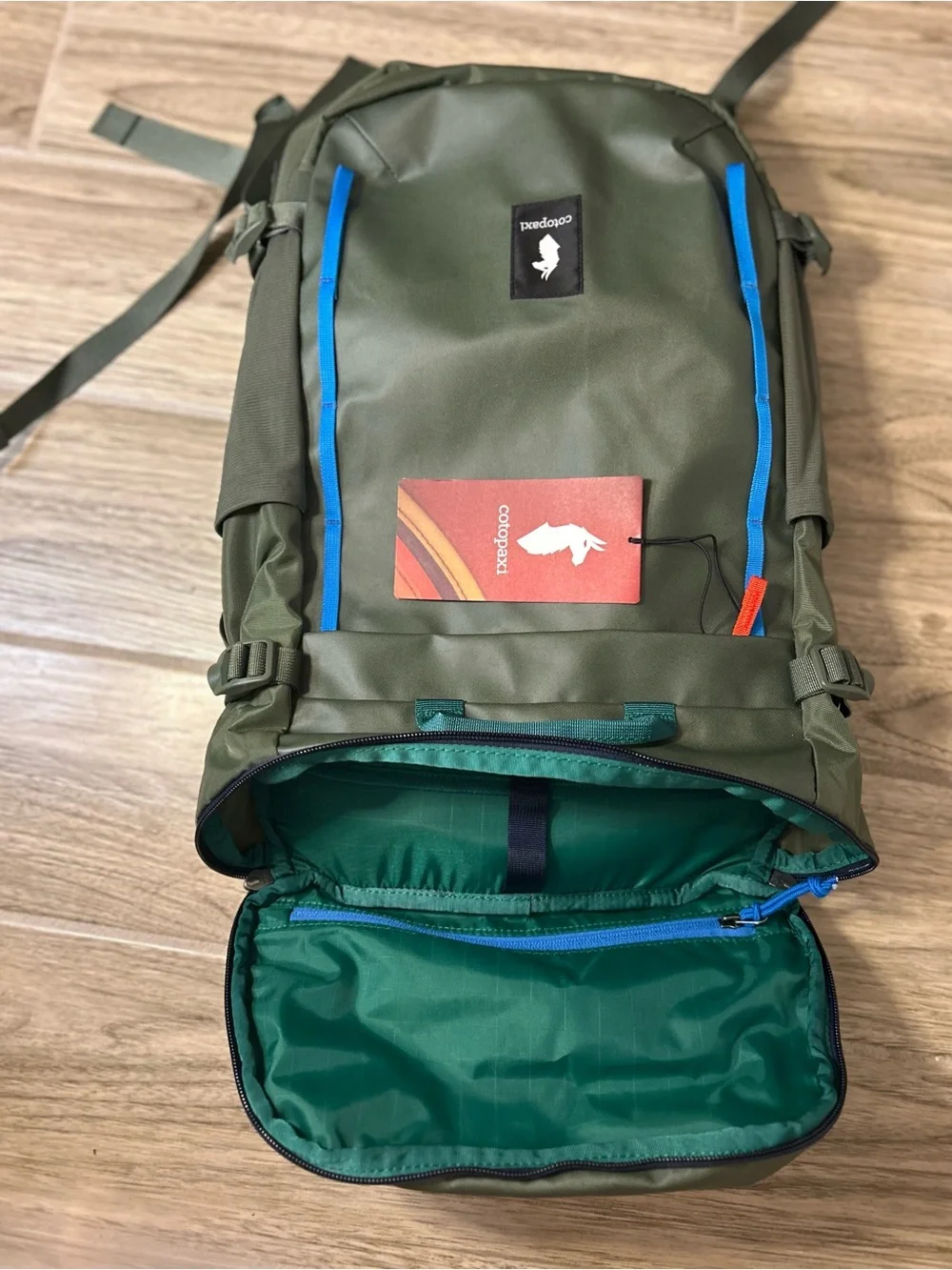 cotopaxi Olive Green Backpack with Blue and Teal Accents